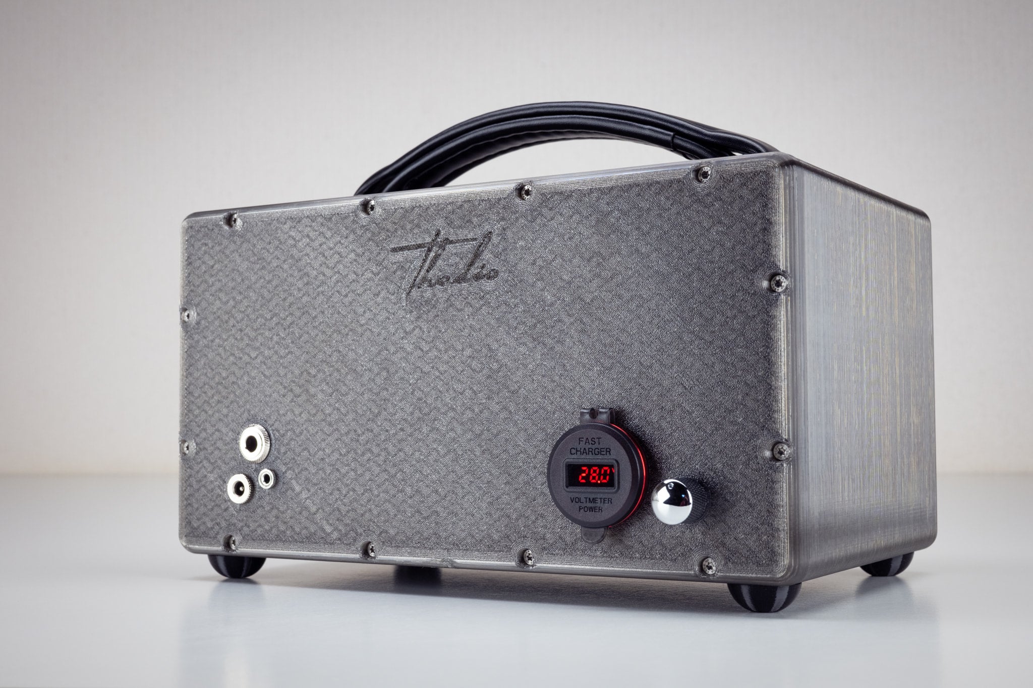 Back of the grey gunmetal Thodio iBox Mini 3D-printed speaker showing USB fast charger, power voltmeter, aux input jacks and embossed Thodio logo