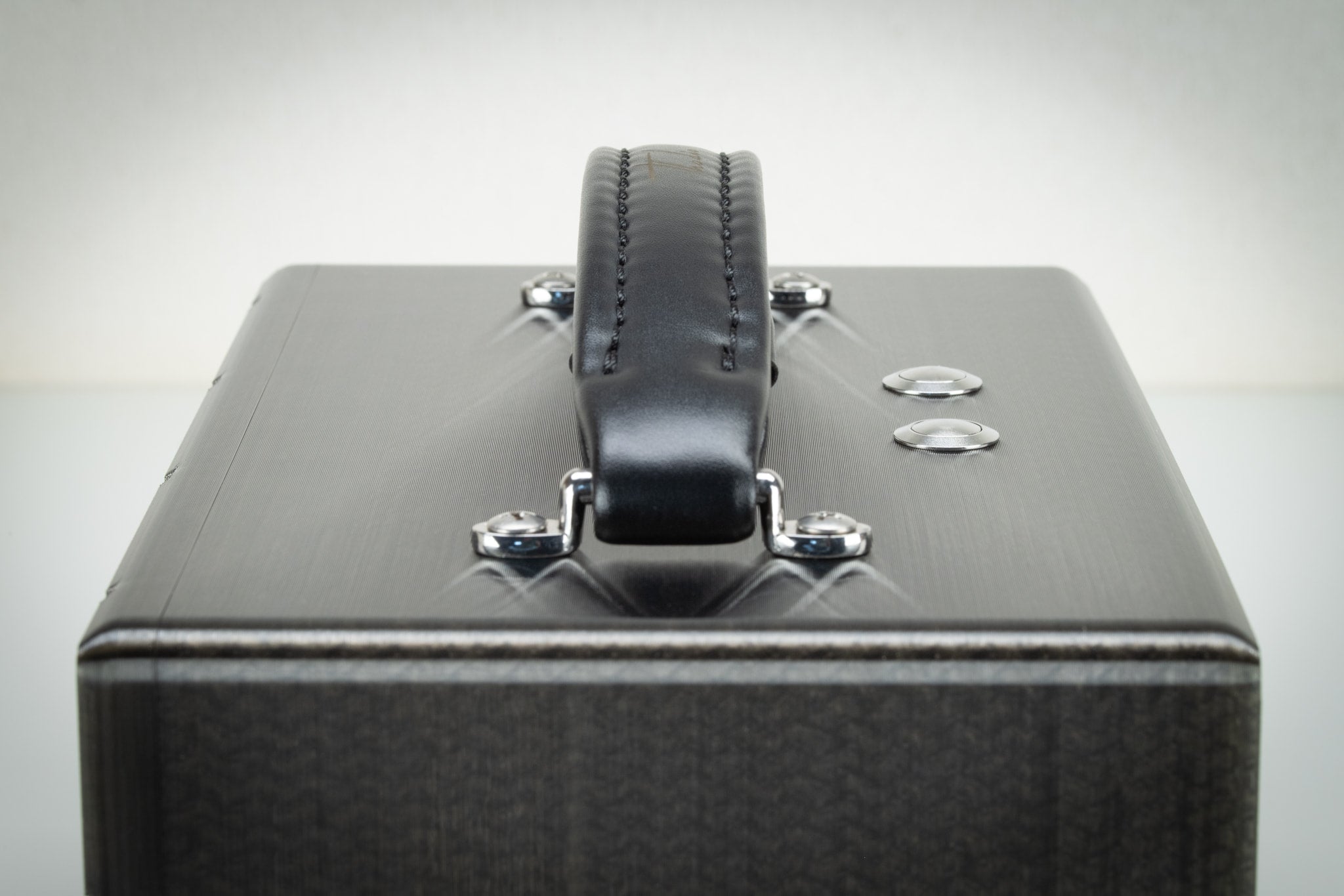 Front detail of the padded leather carry handle and Thodio logo on the grey iBox Mini 3D-printed speaker