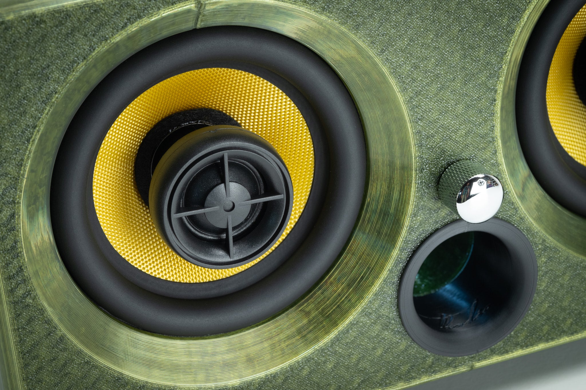 Macro detail of a Thodio speaker driver showing the Kevlar coaxial cone and silk-dome tweeter