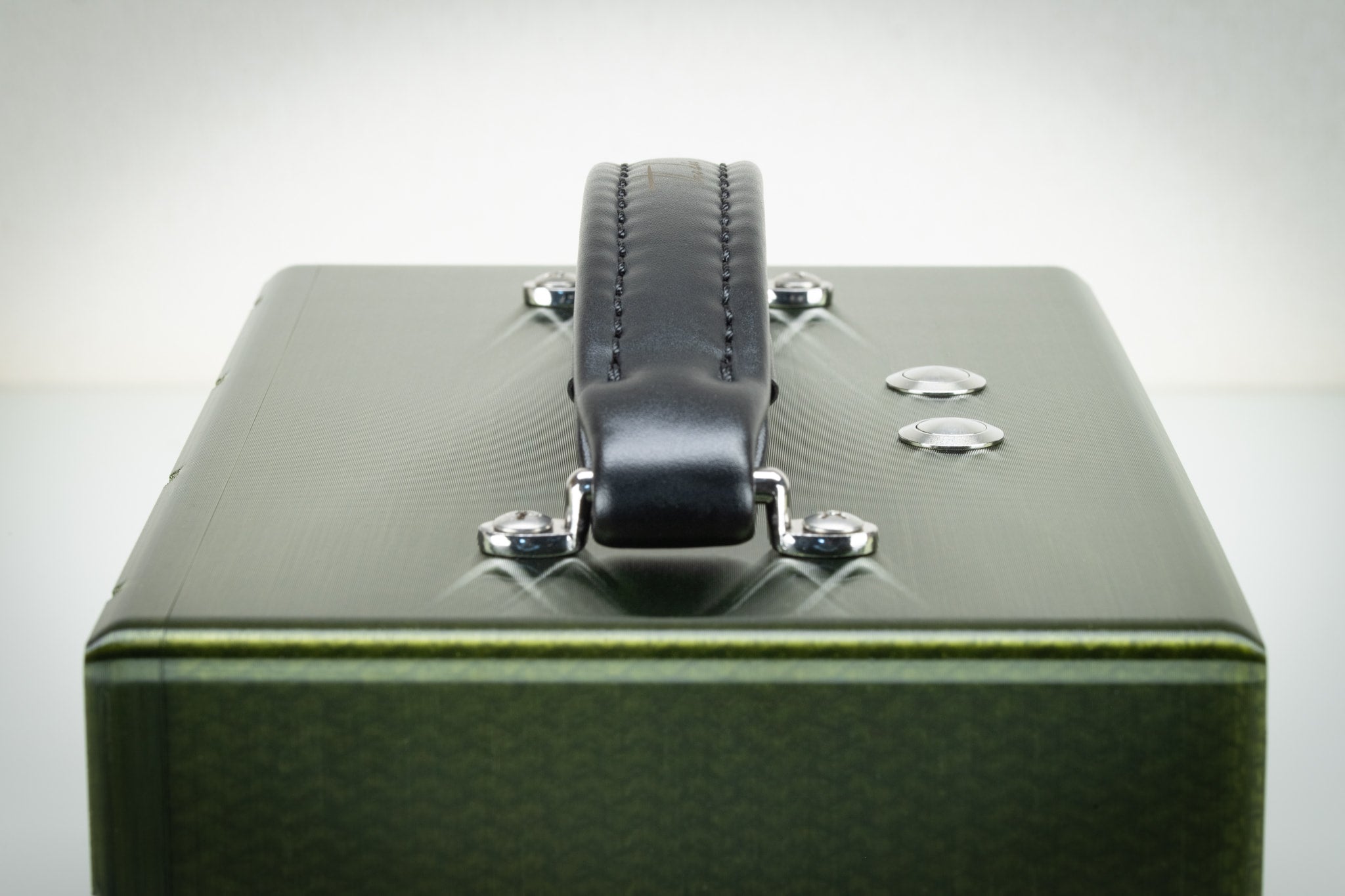 Top view of the handmade Thodio 3D-printed Bluetooth speaker with padded leather carry handle and stainless steel control buttons 