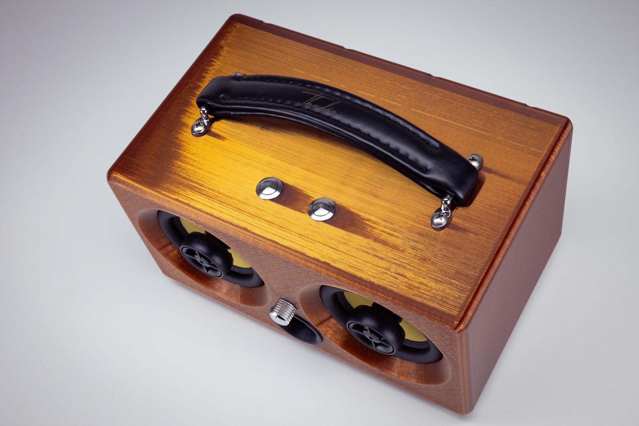 Top view of the amber Thodio iBox Mini 3D-printed Bluetooth speaker with padded leather carry handle and chrome control buttons