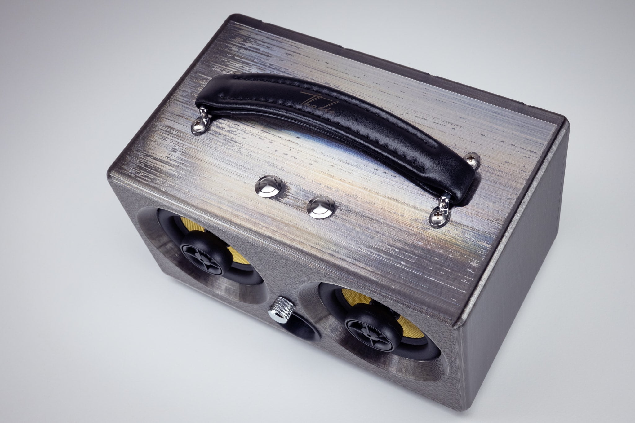 Top view of the grey Thodio iBox Mini 3D-printed Bluetooth speaker with padded leather carry handle and chrome control buttons