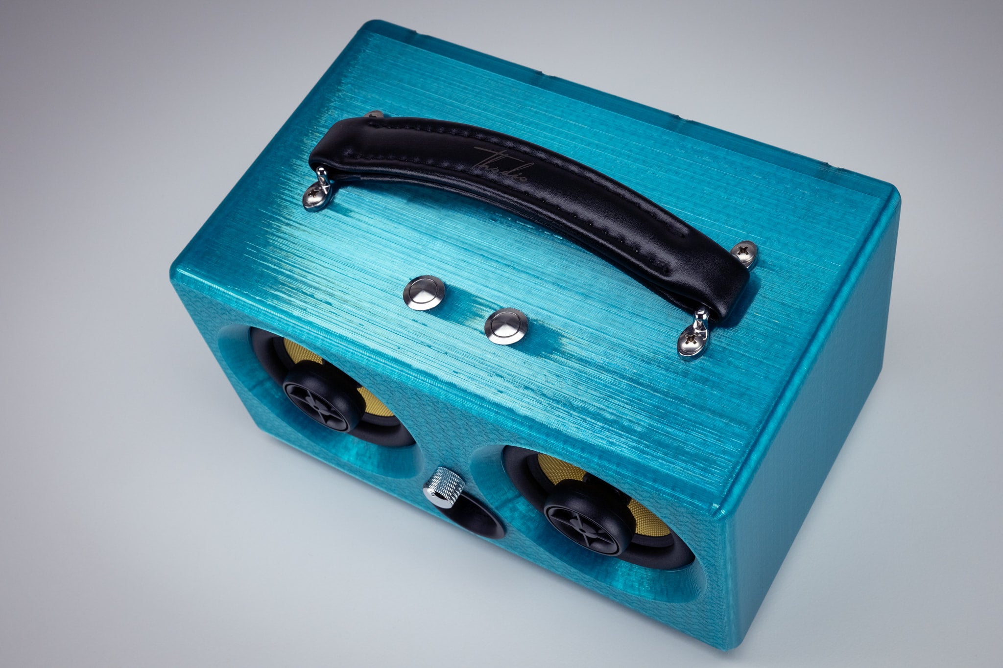 Top view of the turquoise Thodio iBox Mini 3D-printed Bluetooth speaker with padded leather carry handle and chrome control buttons