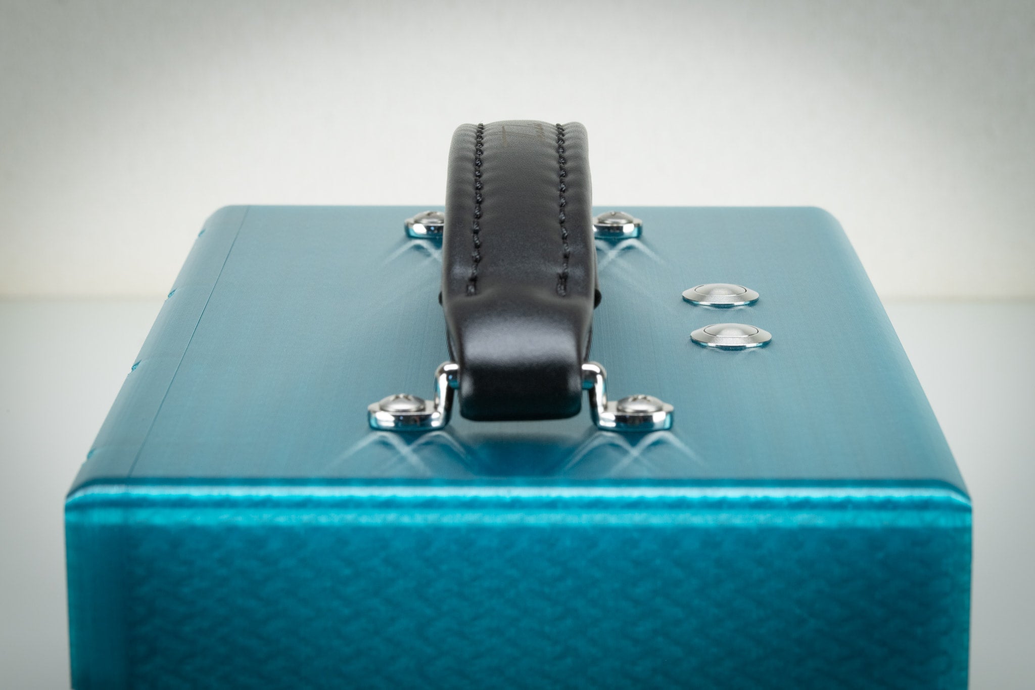 Front detail of the padded leather carry handle and Thodio logo on the turquoise iBox Mini 3D-printed speaker