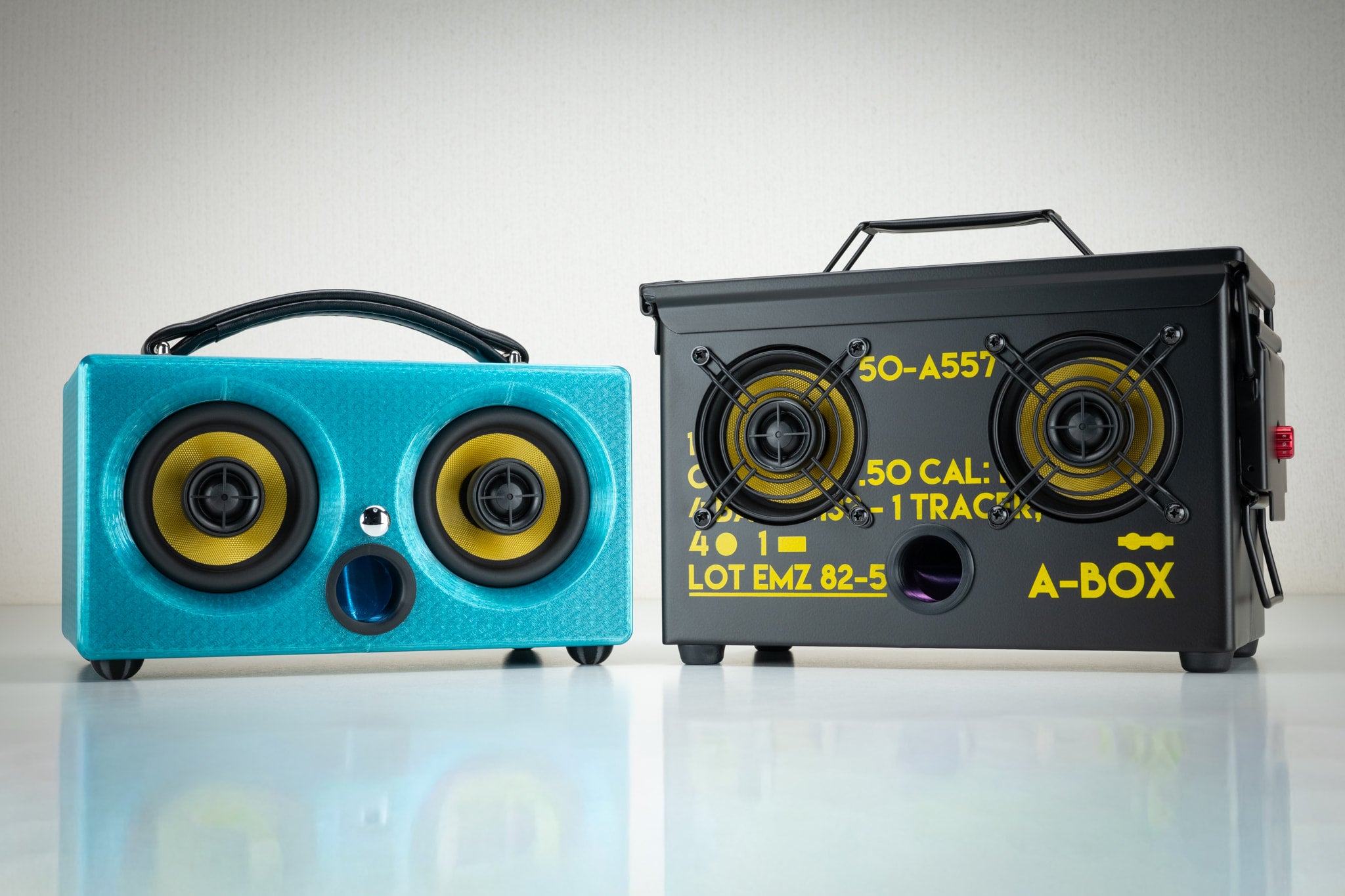 Turquoise Thodio iBox Mini 3D-printed Bluetooth speaker beside the .50 cal ammo can A-BOX speaker for comparison
